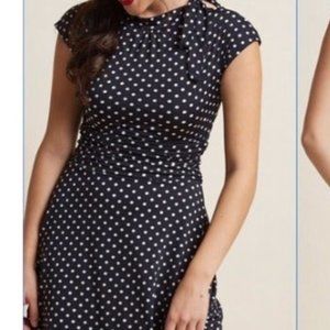 Retrolicious polka dot date night dress with ruched waist and bow at neckline